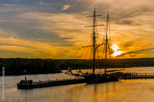 Two-masted brig moored at sunset at the pier Fototapeta