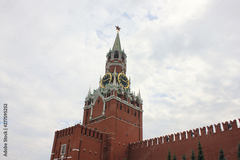 Kremlin tower and wall on Red square, main square of russian capital - Moscow city on cloudy day. Majestic Kremlin building on dramatic sky background Kremlin tower and wall on Red square, main square of russian capital - Moscow city on cloudy day. Majestic Kremlin building on dramatic sky background