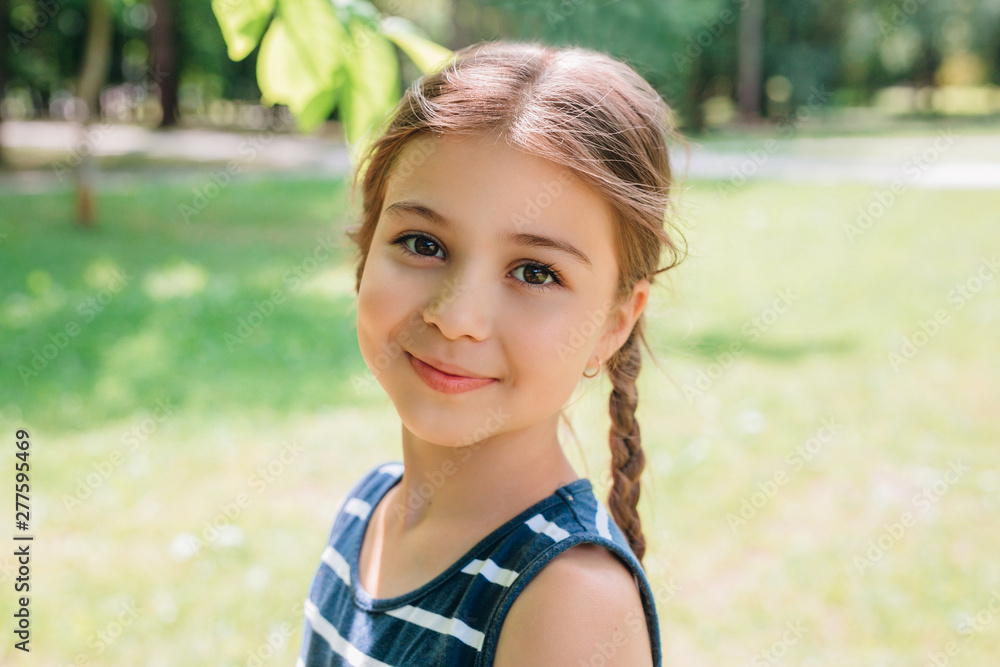 Portrait of adorable smiling little girl with pigtails outdoor in summer day Portrait of adorable smiling little girl with pigtails outdoor in summer day