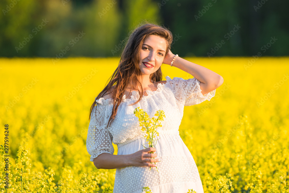 Pregnant girl on the rapeseed field. cute young woman waiting a baby Pregnant girl on the rapeseed field. cute young woman waiting a baby
