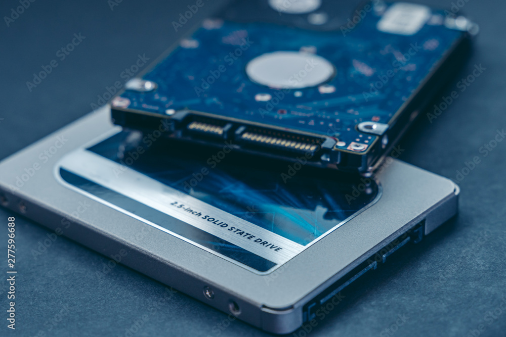 SSD drive and 2.5 HDD drive. Solid State Drive vs traditional HDD,  isolated. Fast storage device vs slow. Stock Photo | Adobe Stock