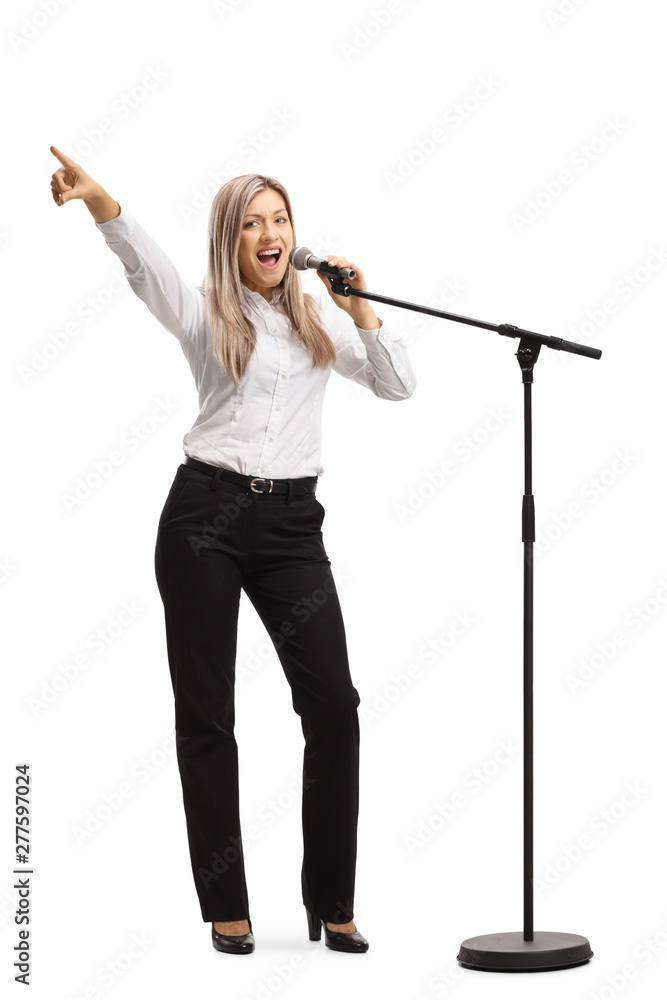 Young blond woman with a microphone gesturing with finger Young blond woman with a microphone gesturing with finger