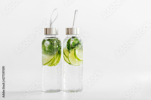 Fresh lime and mint infused water, cocktail, detox drink, lemonade in reusable bottles. Summer drinks. Health care concept.
