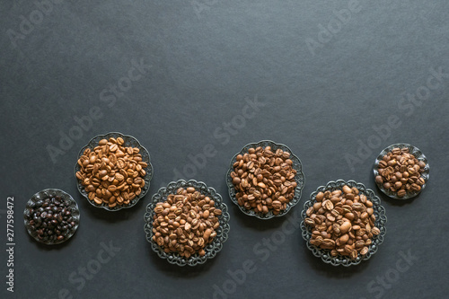 Varieties of roasted coffee beans on a black table