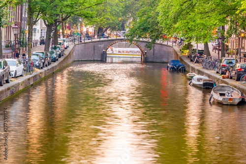 Reflection on a canal with a bridge in Amsterdam