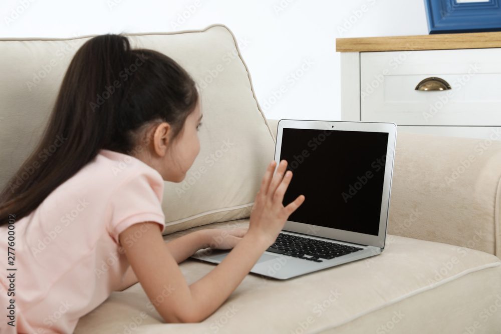 Little girl using video chat on laptop at home. Space for text Little girl using video chat on laptop at home. Space for text