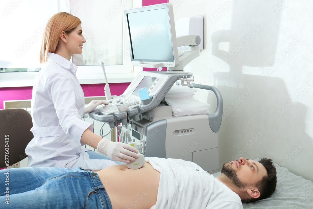 Doctor conducting ultrasound examination of internal organs in clinic. Space for text Doctor conducting ultrasound examination of internal organs in clinic. Space for text
