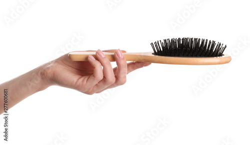 Woman holding wooden hair brush against white background, closeup