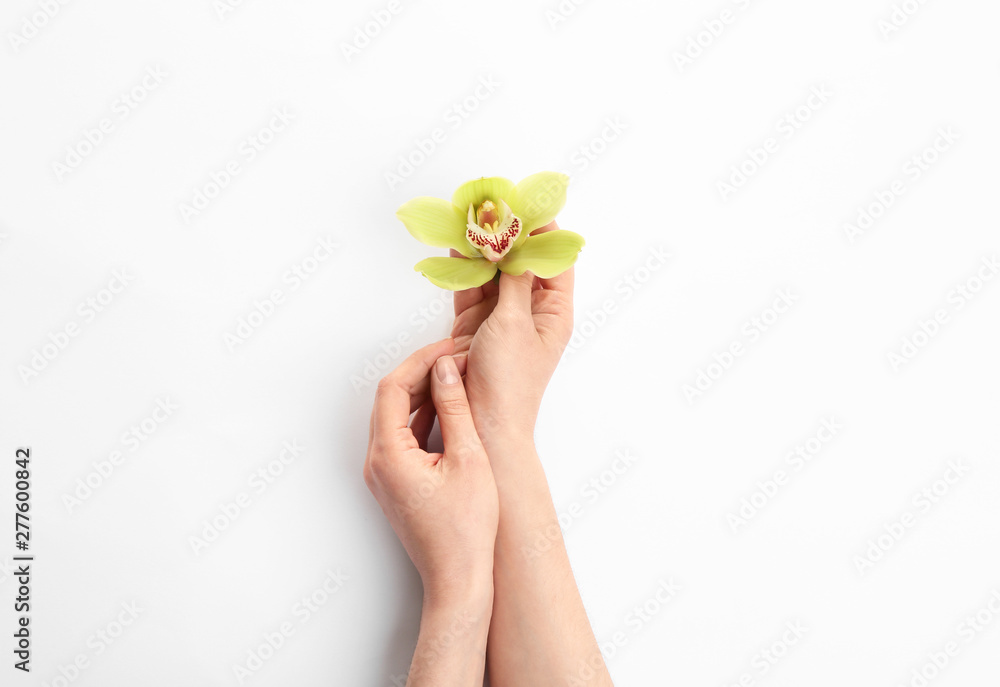 Young woman holding beautiful orchid flower on white background Young woman holding beautiful orchid flower on white background