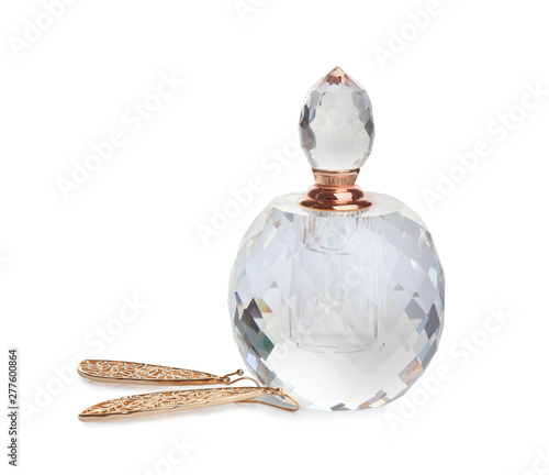 Glass bottle of perfume and luxury jewellery isolated on white