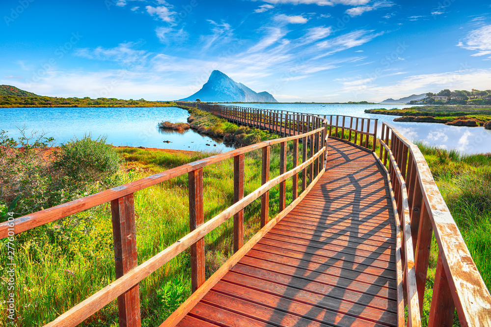 Sunrise from a pedestrian walkway to Porto Taverna beach.