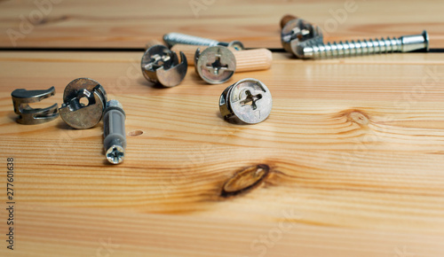 Construction tools. The screws, nuts and bolts on wooden background. Repair home improvement concept