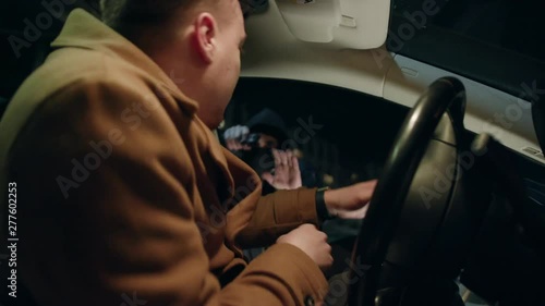 Shot inside in car gangster with gun attacked a man at night street thief lady criminal assault bandit burglar danger dangerous parking people risk rob robber desperation armed auto illegal pistol