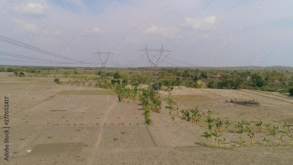 Electricity pylons bearing power supply across rural landscape. aerial ...