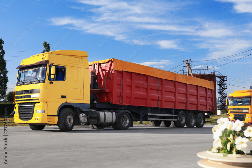 Modern bright trucks parked on country road