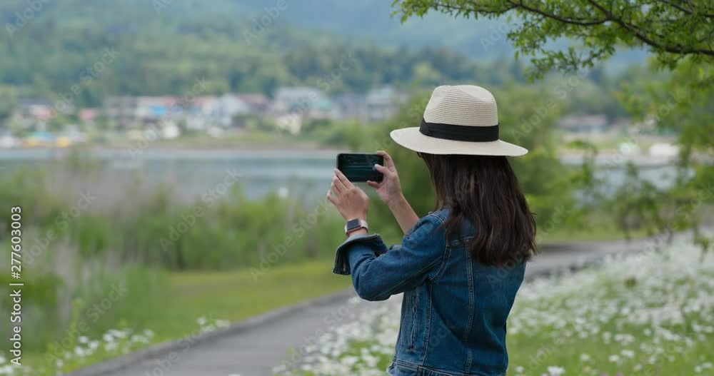 Woman take photo with cellphone in countryside Woman take photo with cellphone in countryside