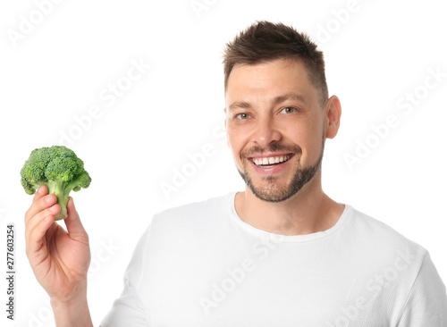 Portrait of happy man with broccoli on white background