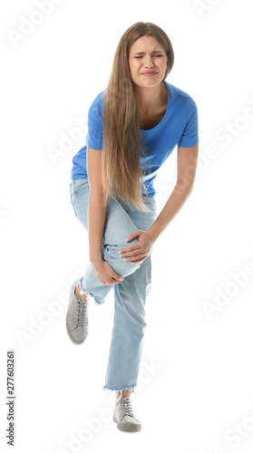 Full length portrait of woman having knee problems on white background