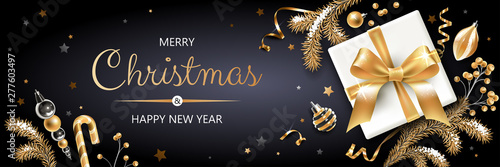Horizontal banner with gold and silver Christmas symbols and text. Christmas tree, gift, decoration and other festive elements on black background.
