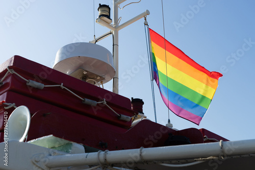 LGBT rainbow gay flay on the ship in a sunny day on the sea summer photo