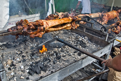 Roasting of young piglets on the grill and fire