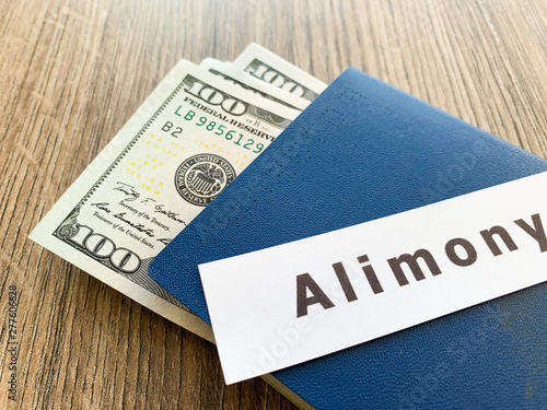 Payments alimony. Pile Dollars with sign alimony and money. Divorce and separation concept.