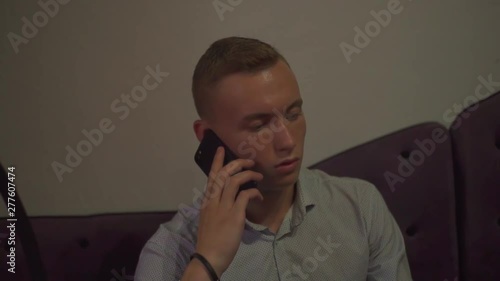 A young guy talking on the phone bar, hookah, cafe. photo