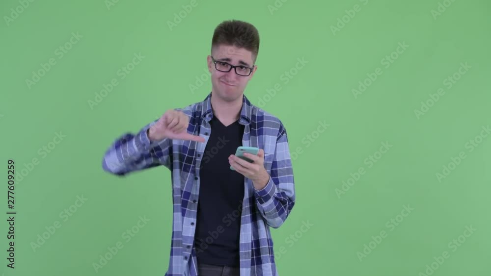 Stressed young hipster man using phone and getting bad news Stressed young hipster man using phone and getting bad news