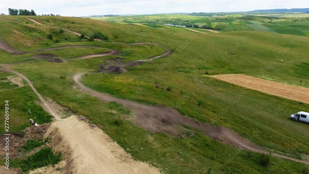 Aerial top down view of motocross track showing the high-performance off-road motorcycles racing on the enclosed manmade dirt circuit with steep jumps and obstacles 4k high resolution quality footage Aerial top down view of motocross track showing the high-performance off-road motorcycles racing on the enclosed manmade dirt circuit with steep jumps and obstacles 4k high resolution quality footage