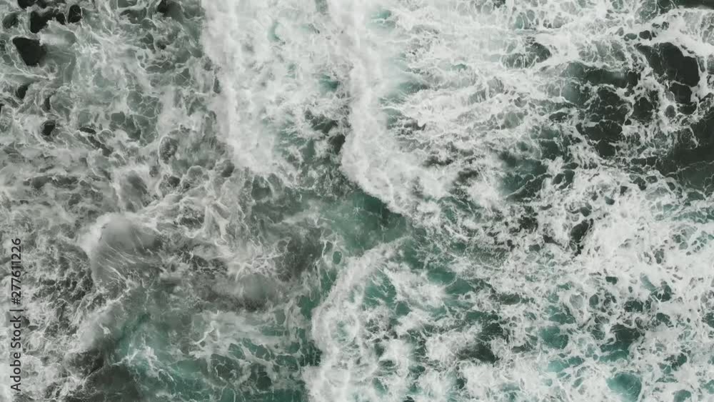 Aerial view. Very beautiful view of the Atlantic coast, aquamarine color of the waves falling on the beach of volcanic origin, Tenerife, Spain Aerial view. Very beautiful view of the Atlantic coast, aquamarine color of the waves falling on the beach of volcanic origin, Tenerife, Spain