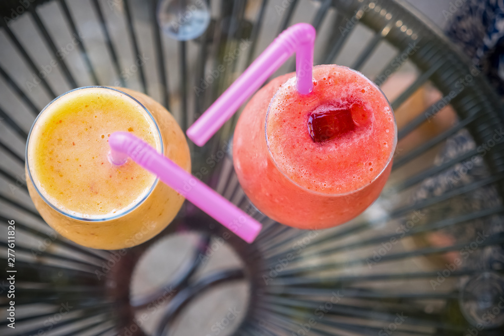 Refreshing drink with ice. Summer drinks. Freshly blended fruit smoothies  of various colors and tastes in glass jars. Grapefruit, strawberry cocktail.  Vegan drinks on glass table. Detox concept Stock Photo | Adobe