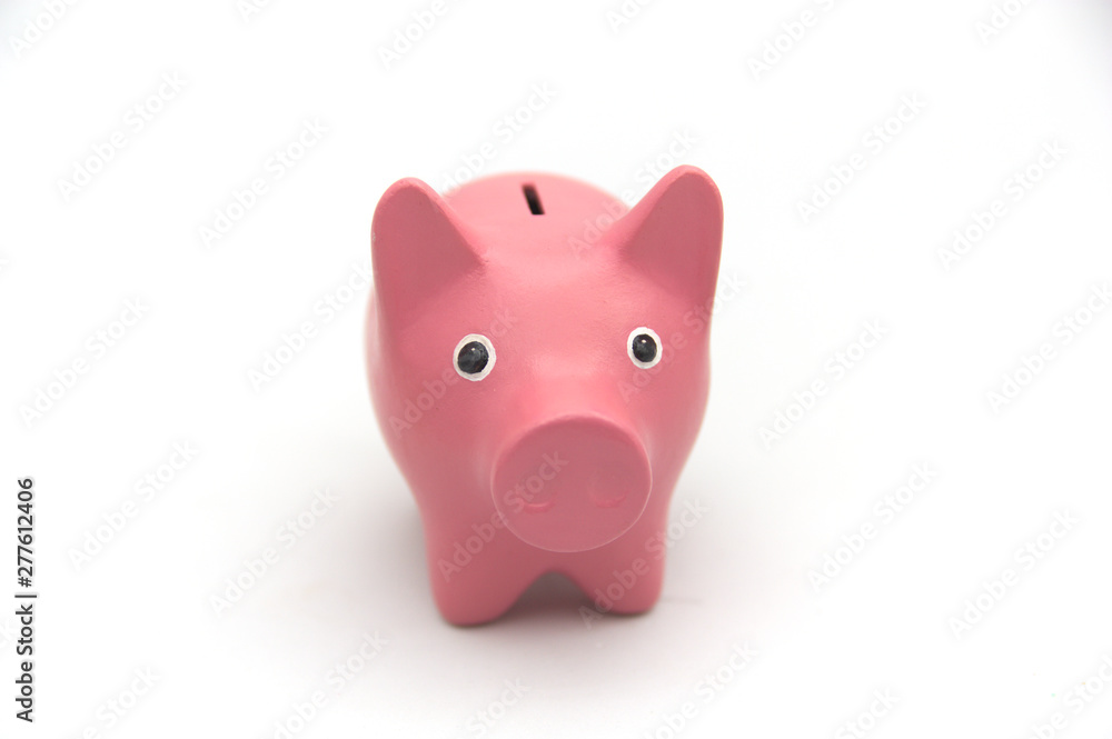 Piggy bank in pink color on white background looks at camera