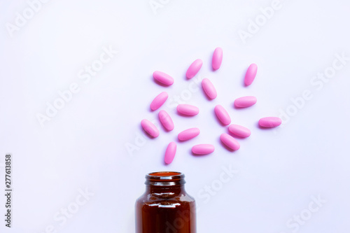 Pink medicine pills on white