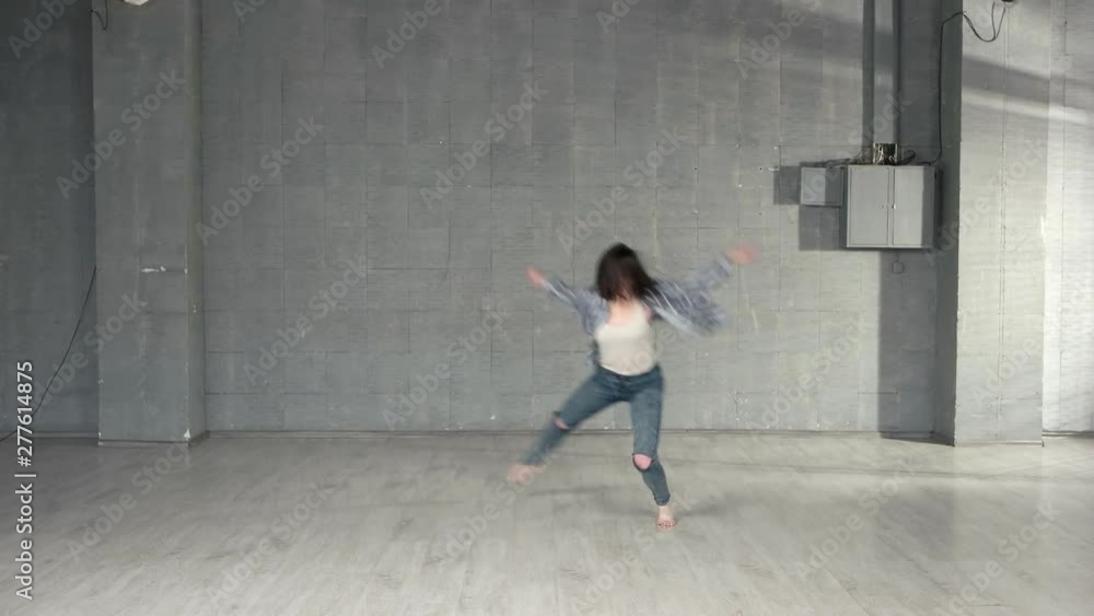 Young woman performing modern dance. Beautiful caucasian girl performs contemporary dance in modern studio. Young woman performing modern dance. Beautiful caucasian girl performs contemporary dance in modern studio.