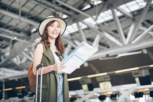 Asian woman tourist is looking for travel information. She has a map in her hand