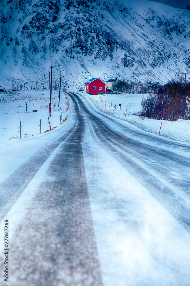 Lonely Red Rorbu House in Mountain Village at Lofoten Islands in Winter Time. Lonely Red Rorbu House in Mountain Village at Lofoten Islands in Winter Time.