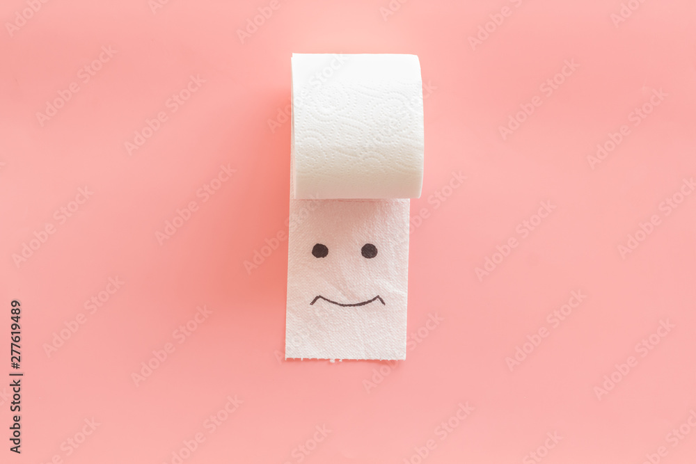 Toilet paper roll with painted face for proctology diseases concept on