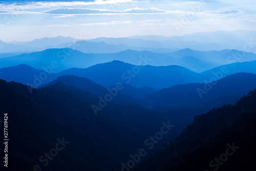 Majestic sunset sky over blue mountains layers landscape