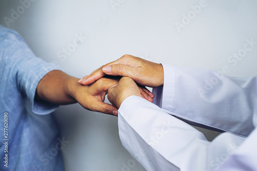 Hand of doctor reassuring her female patient,Partnership, trust and medical ethics concept. Bad news lessening and support. Patient cheering and support,Take care and trust concept, photo