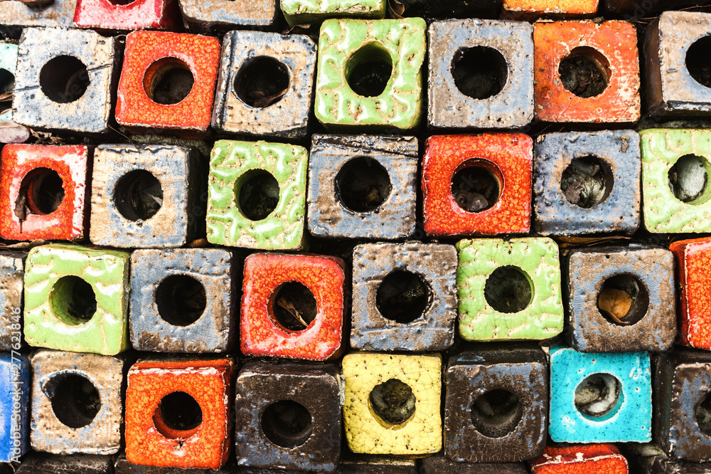 Fototapeta premium Multicolored decorated cubes brick wall with hole design as the abstract textured and background