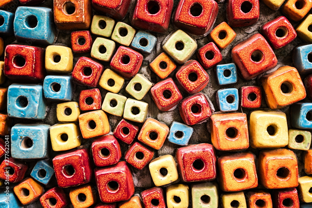 Fototapeta premium Multicolored decorated cubes brick wall with hole design as the abstract textured and background