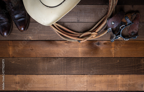 Obraz na plátně American Cowboy Items incluing a lasso spurs and a traditional straw hat on a wo