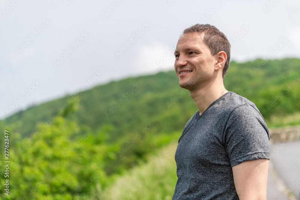 Young happy tourist man standing in Shenandoah Blue Ridge appalachian mountains on skyline drive Stoney Man overlook Young happy tourist man standing in Shenandoah Blue Ridge appalachian mountains on skyline drive Stoney Man overlook