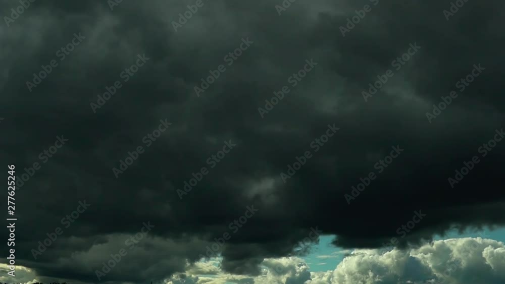 Cloudy time lapse, energy moving cloud on blue sky where clouds change position and change color from light blue to dark grey. Closeup at big clouds. Abstract fluffy, puffy cloudscape Cloudy time lapse, energy moving cloud on blue sky where clouds change position and change color from light blue to dark grey. Closeup at big clouds. Abstract fluffy, puffy cloudscape