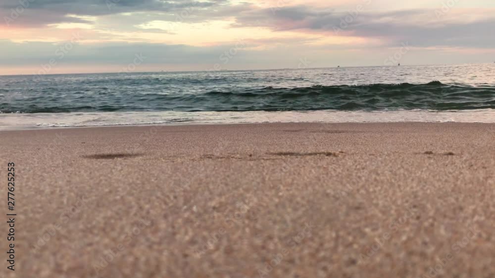 View from below of the sea. The waves end at the beach shore and nice cloudy sky on sunset View from below of the sea. The waves end at the beach shore and nice cloudy sky on sunset