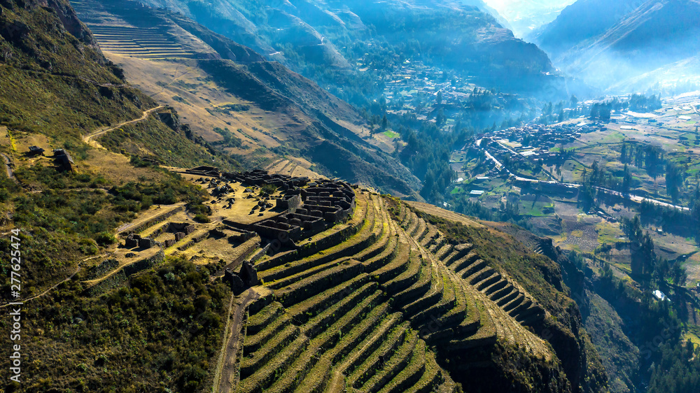 Aerial view of the ancient Inca ruins of Pisac (Pisaq) in the Sacred Valley near Cusco, Peru. Archaeological park with green terraces. - obrazy, fototapety, plakaty 