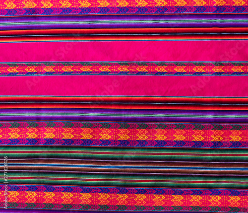 Pink wooven wool from Peru. Traditional fabric background colorful texture. Latin America textile patterns.