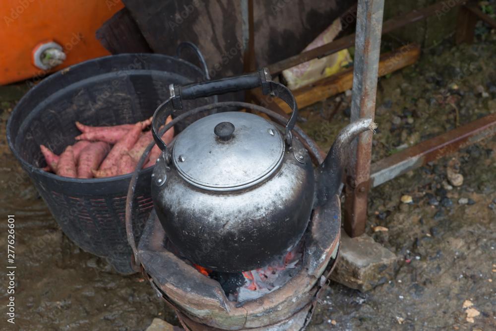 Hot water kettle on a charcoal stove Blurred background image Hot water kettle on a charcoal stove Blurred background image