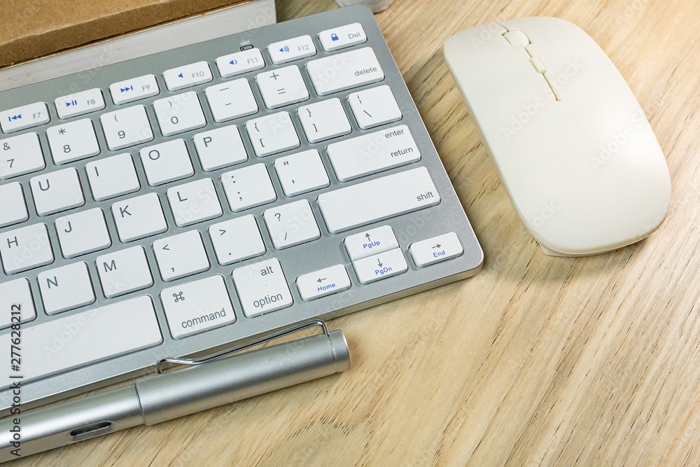 silver keyboard on wood table flat lay image.. silver keyboard on wood table flat lay image..