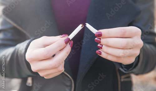 Woman breaking cigarette. Quit smoking